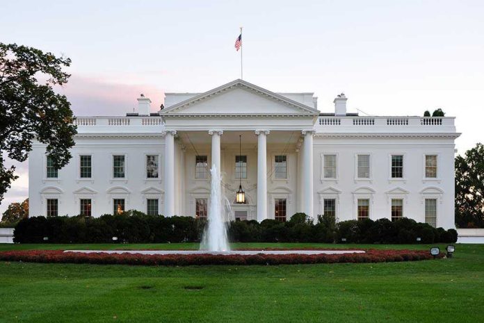 158620832 The White House with fountain and American flag.
