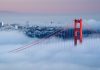 Golden Gate Bridge emerging from fog with San Francisco in the background