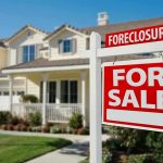Foreclosure sign in front of a house for sale