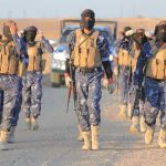 Cartel’s Chilling Disappearance Tactics EXPOSED Camouflaged soldiers wearing masks and vests walk in desert.