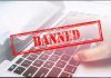 Red Banned stamp over a laptop keyboard.