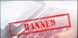 Red Banned stamp over a laptop keyboard.