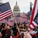 Crowd waving American flags near the U.S. Capitol