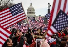 Crowd waving American flags near the U.S. Capitol