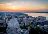 Capitol dome overlooking city and lake at sunrise