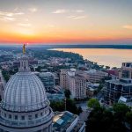 Capitol dome overlooking city and lake at sunrise