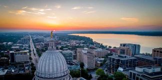 Capitol dome overlooking city and lake at sunrise
